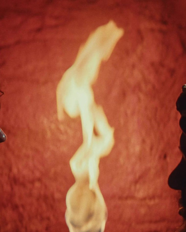 A lit torch against a stone wall — a frame from the proof-of-concept short, The Torch.